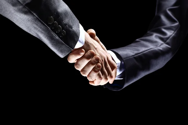 Close-up of business people shaking hands to confirm their partnership — Stock Photo, Image