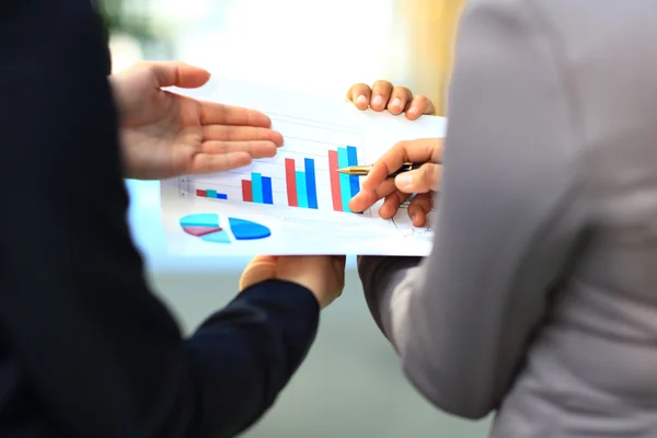 Close-up of graphs and charts analyzed by business people — Stock Photo, Image