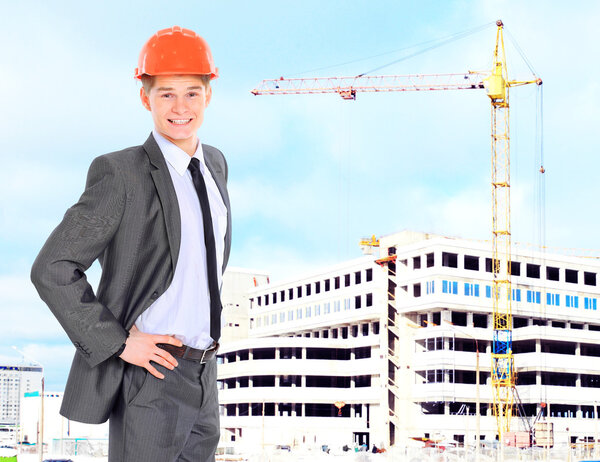 Engineer With Red Hard Hat and Blueprint Under the Power Lines