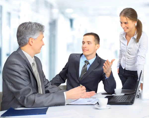 A business team sitting in office and planning work Stock Picture