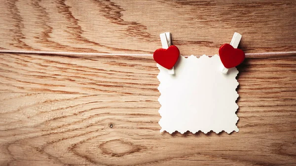 Sheet form with hearts attached to a rope — Stock Photo, Image