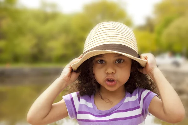Little girl pulling down her hat — Stock Photo, Image
