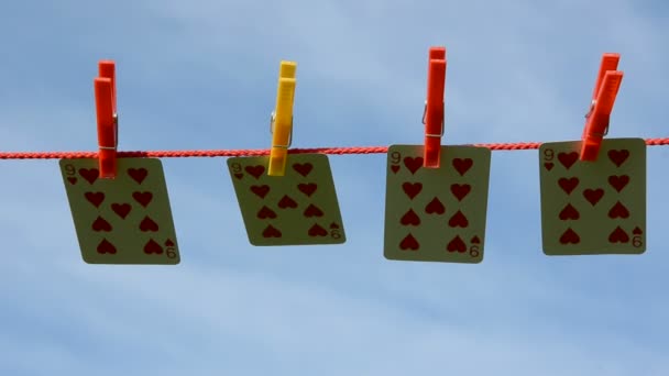 Playing cards on clothes-line and summer wind — Stock Video