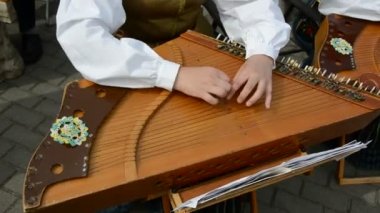 Girl playing with stringed instrument