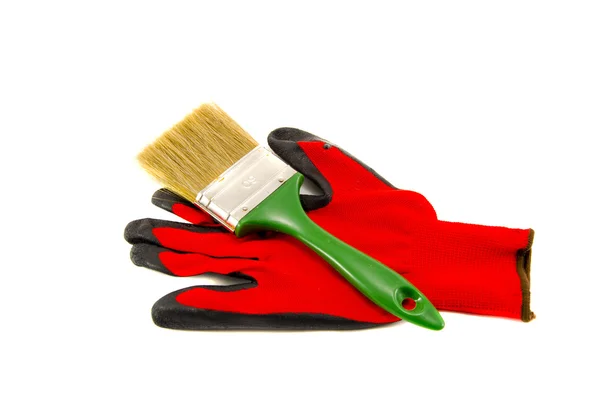 Изолированная красная защитная перчатка и инструмент кисти — стоковое фото