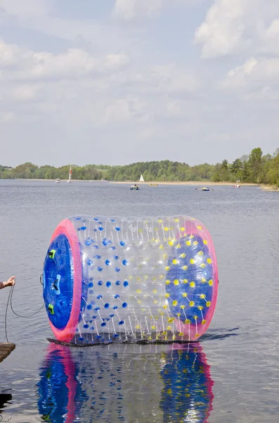 Empty zorbing ball on lake water — Stock Photo, Image