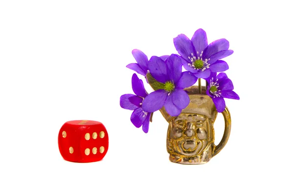 Red dice and brass vase with violet flowers — Stock Photo, Image