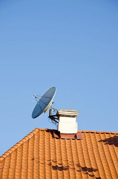Tv satellite dish on roof in old town Stock Image