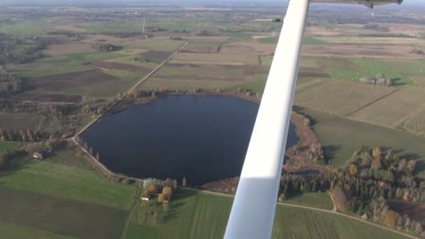 Aerial view over autumn lake and fields — Stock Video