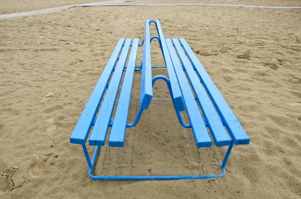 Blue bench on sea beach sand — Stock Photo, Image