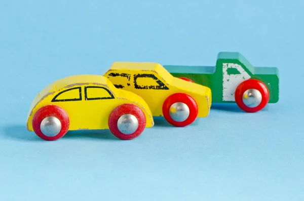 Three wooden cars toys on azure background — Stock Photo, Image