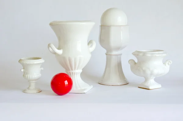 Still-life with white vases and red billiards ball — Stock Photo, Image