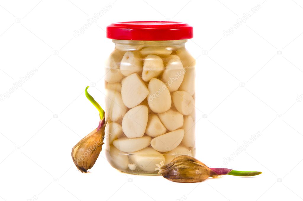 pickled garlic in glass jar and sprin garlic sprouts