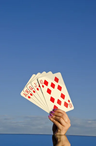 Playing cards in woman hand and sky space — Stock Photo, Image