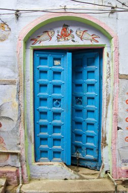 ancient blue wooden door in Varanasi,India clipart