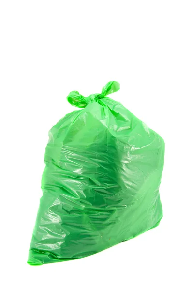Worek na śmieci pełen zieleni na białym tle — Zdjęcie stockowe