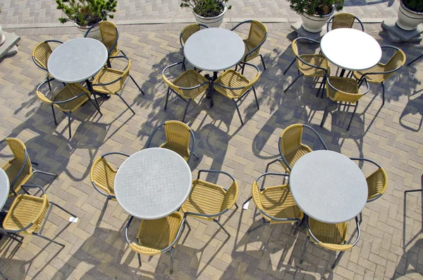 Street cafe tables and chairs on pavement — Stock Photo, Image