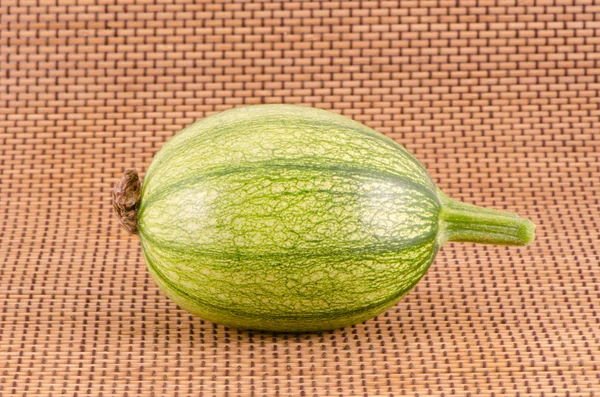 Fresh young zucchini vegetable on wooden background — Stock Photo, Image