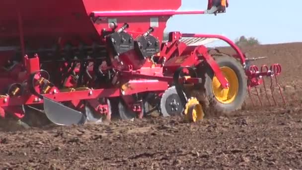 Agriculture machine sowing seeds and cultivating field — Stock Video