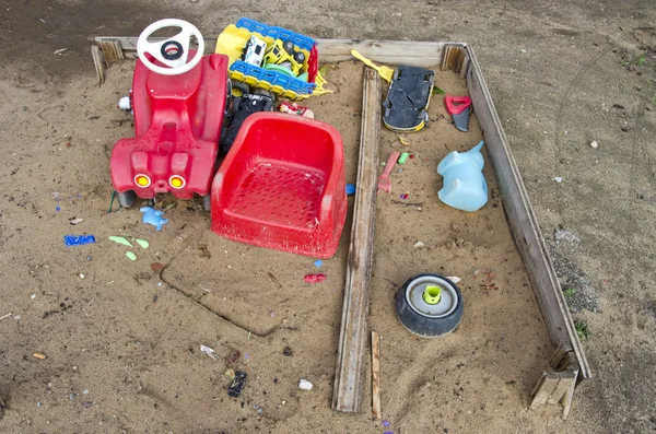 Old playground childrens sandbox with toys — Stock Photo, Image