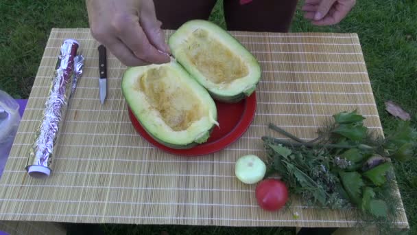 Hand adding salt for fresh zucchini on table — Stock Video