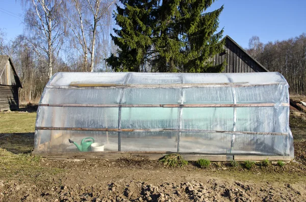 Plastic greenhouse in spring farm garden — Stock Photo, Image