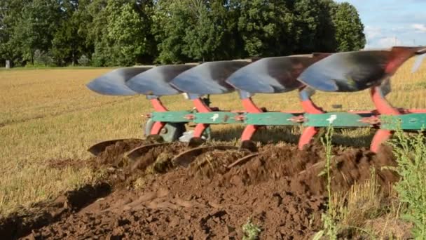 Tractor slowly ploughing farm field soil — Stock Video