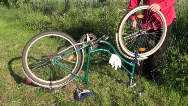 Repair old bicycle on farm yard — Stock Video