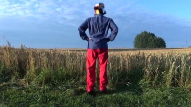 Funny farmers with clown cap morning exercise on field