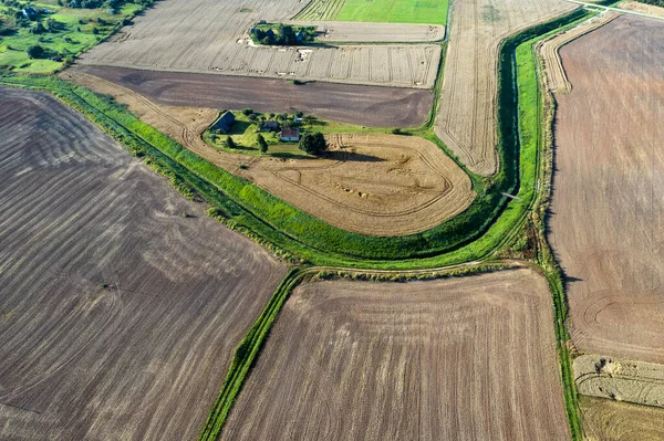 farm fields and homestead in summer end, aerial view