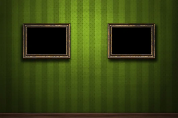Old wooden frames on green retro grunge wall — Stock Photo, Image