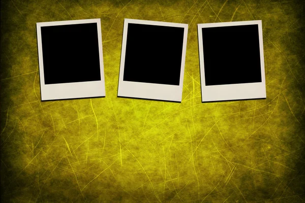 Blank instant photo frames on grunge yellow background — Stock Photo, Image