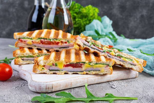 Sandwich with ham, cheese, mustard leaves, tomatoes and onion. Tasty club sandwiches