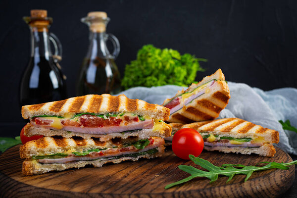 Sandwich with ham, cheese, mustard leaves, tomatoes and onion. Tasty club sandwiches
