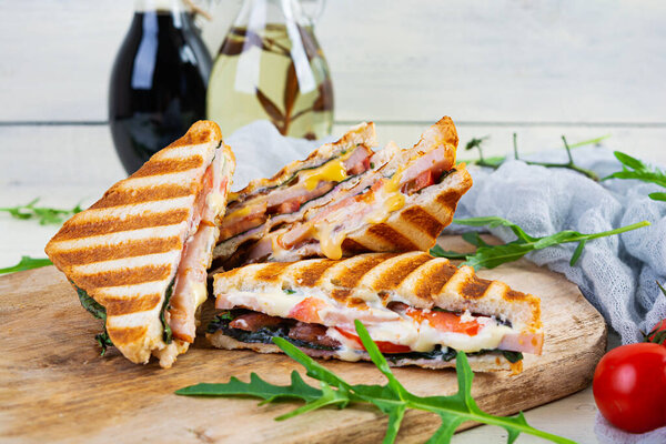 Sandwich with ham, cheese, mustard leaves, tomatoes and onion. Tasty grilled sandwiches