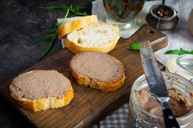 Sandwich with chicken liver pate on dark background