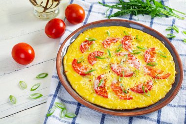 Omelette with tomatoes, herbs and grated cheese. Easy breakfast