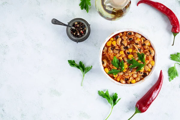 Chili con carne in a bowl. Mexican cuisine. Chili with meat, corn and beans