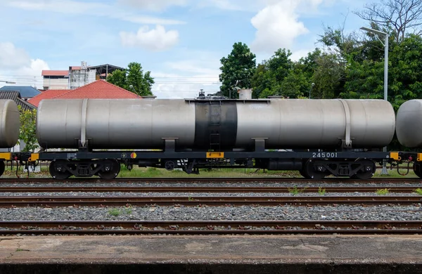 The bogie of the oil tanker in the freight train is parking in the railway yard of the city station, waiting to contain the oil in the oil depot, front view with the copy space.