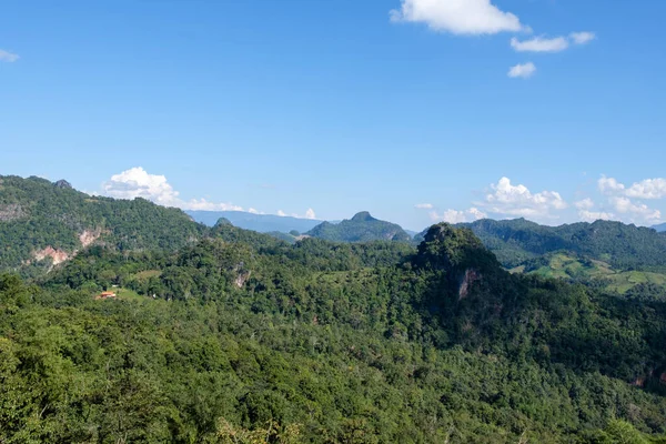 The plantation area of the hill tribe is on the limestone mountain range near the national park in northern Thailand, front view with the copy space.