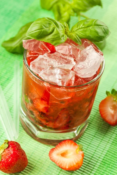 Red drink on a green background — Stock Photo, Image