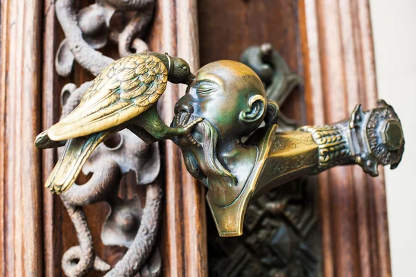 Decorative antique, metal door handles with bird pattern. — Stock Photo, Image