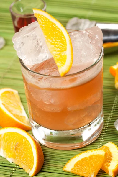 Orange drink on a green background — Stock Photo, Image