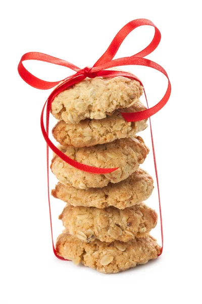 Six oatmeal cookies tied with a red ribbon, isolated on white — Stock Photo, Image