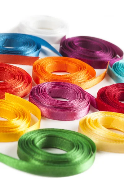 Coiled spools of colorful ribbons on a white background — Stock Photo, Image