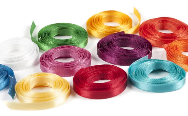 Coiled spools of colorful ribbons on a white background — Stock Photo, Image