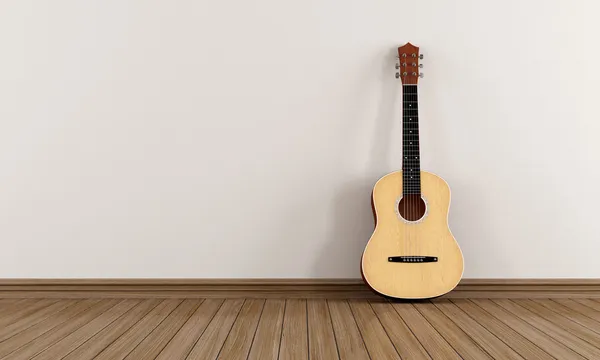 Guitarra acústica em uma sala vazia — Fotografia de Stock