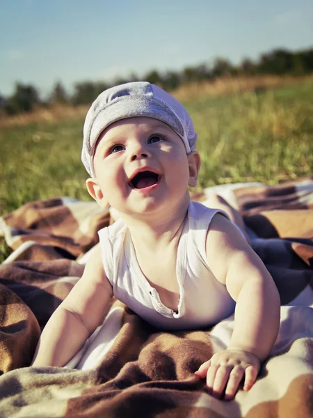 Un niño sentado en la hierba —  Fotos de Stock