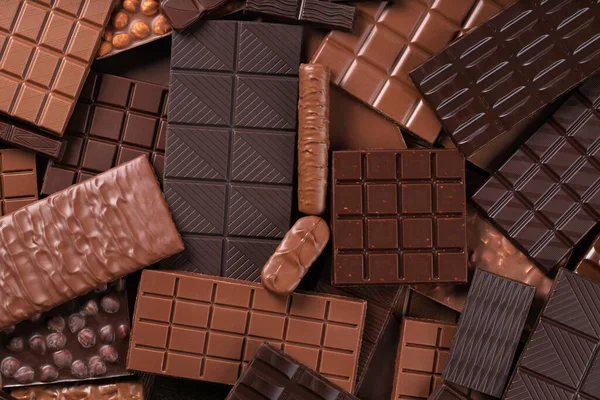 Organic chocolate background, pile of cocoa bars, top view.