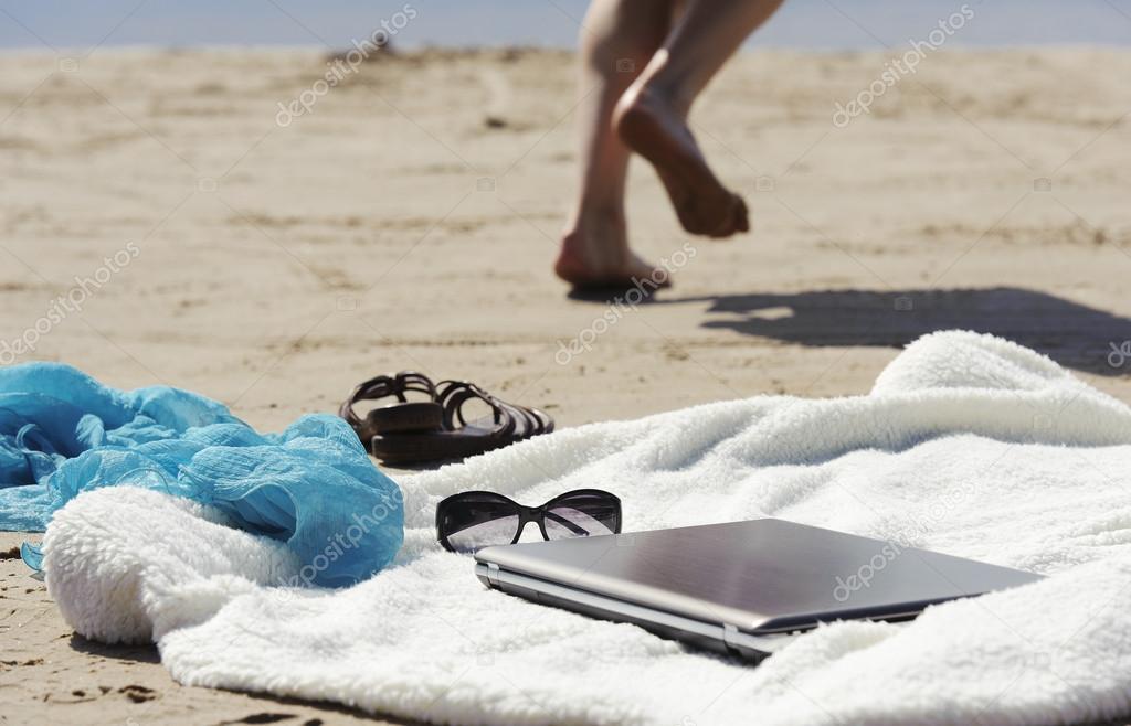 Wrap, laptop, scarf and mules on the beach